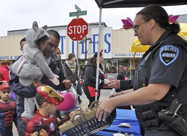 Auburn Police Officer Jessica Smith gives out candy to trick-or-treaters