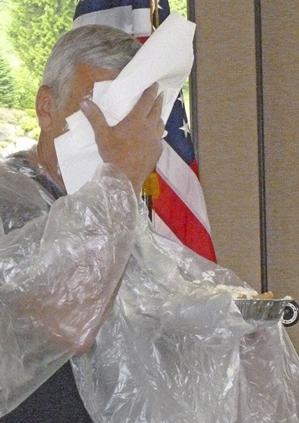 Mickey Kimmerle wipes the pie from his face during the recent Rotary Club of Auburn meeting.