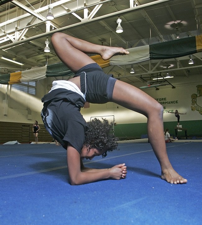 Alexis Moore practices on the floor at Auburn High School.