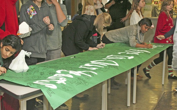 Auburn High School students and staff expressed personal words of sympathy on a large handmade banner with the words