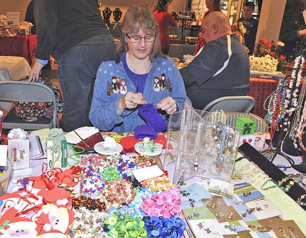 Julie Bagley sells her items during the recent Holiday Bazaar and Bake Sale at the Messiah Lutheran Church. The event included 50 tables of handcrafted items