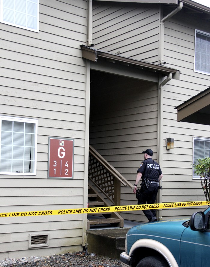 A Pacific police officer at the Cobble Court Apartments where the department is investigating the killing of a 13-year-old boy.