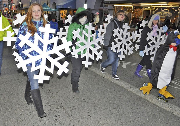 Snowflake-clad Girl Scouts march down Main Street