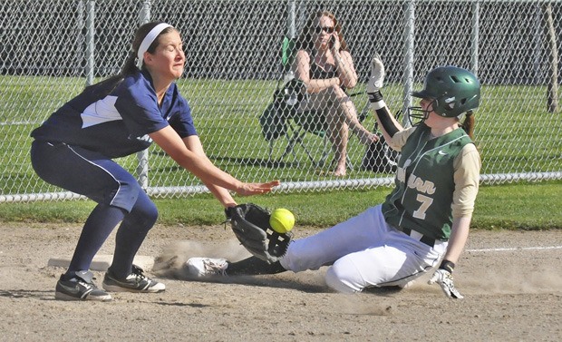 Auburn's Megan Carver slides in safely at third in front of Auburn Riverside's Kylie Adams.