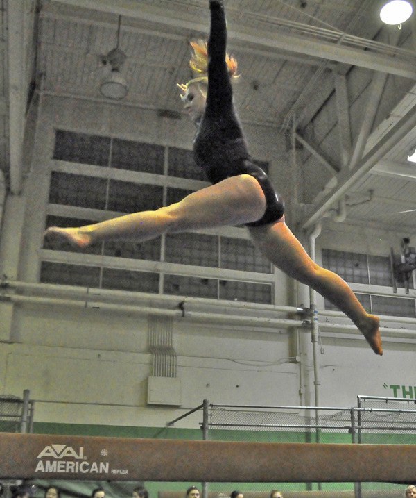 Auburn senior Bailie Davis runs through her routine on the beam.