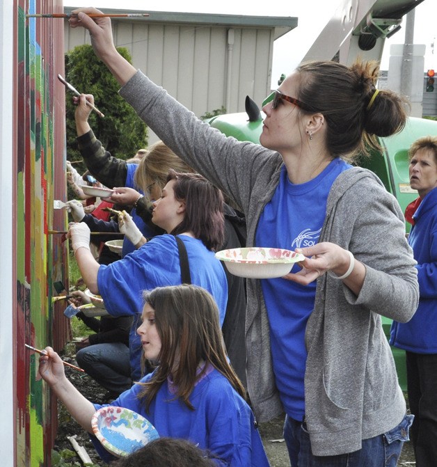 Volunteers from the Sound Mental Health Group painted a mural on the Red Barn Building on Main Street last Saturday. It was part of Clean Sweep