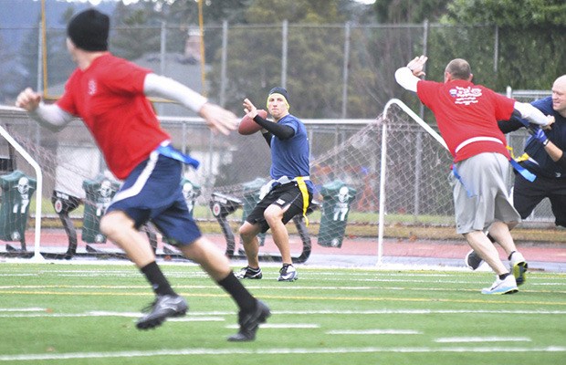 Auburn Police Officer Chris Danninger spots a downfield receiver during the Battle of the Badges Holiday Football Game IX last Saturday at Auburn Memorial Stadium. The firefighters prevailed