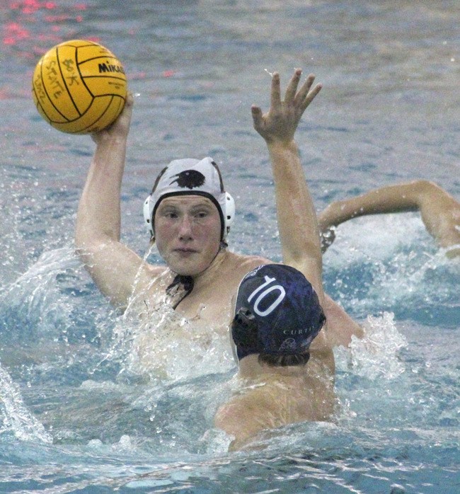 Auburn Riverside Senior Thomas Henline shoots over an Auburn Mountainview opponent at the Washington State Boys Water Polo championships.