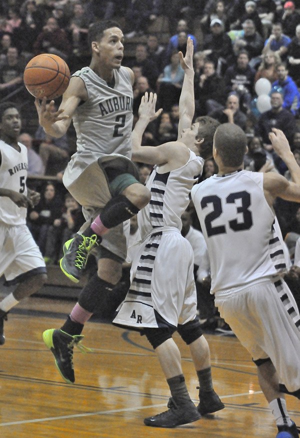 Auburn's Marquise Prater elevates for a shot over Raven players  Mitch Wetmore and Earl Taylor Jr.