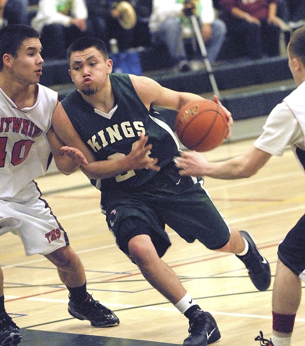 Muckleshoot Tribal Kings’ Antonio Cabanas  drives past a Taholah defender at the state 1B boys basketball tournament.