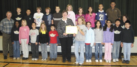 Honorable donation: Members of the Arthur Jacobsen Elementary School’s National Honor Society present a check for more than $200 to Lynn Norman