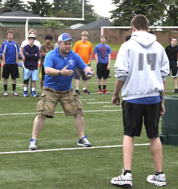 The Auburn Reporter's Coach of the Year Jared Gervais drills with incoming freshman at an Auburn Mountainview football practice.