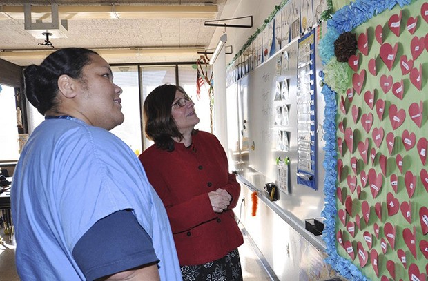 Holy Family School Principal Michele Corey shows Tino Veltri a classroom during an open house this week. To learn more about the school