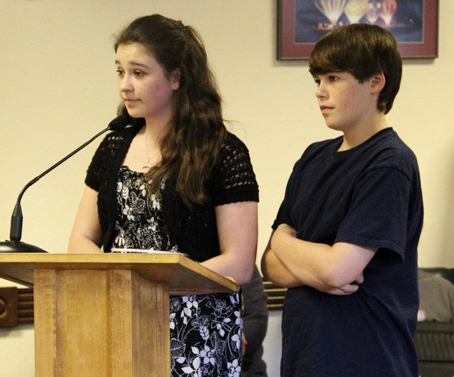 Jaclyn Leibrant and Tristan Howard speak in front of the Pacific City Council on Monday. The Mount Baker eighth graders are organizing a candlelight memorial for slain seventh-grader Walter Denesha.