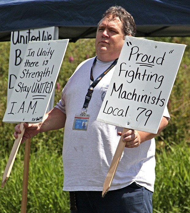 Union worker Mark Walker from Belshaw Adamatic Bakery Group joins the picket line.