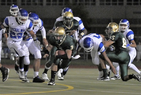 Junior Austin Embody breaks through the Federal Way line during the Trojans opening game of the 2009 season.