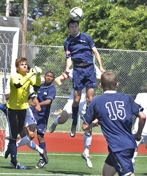 Auburn Riverside's Jakob Middlebrooks attempts to head one out of the box during the Raven's battle for third-fourth place at the Washington State 3A Boys Soccer championships. Also pictured from Auburn Riverside is