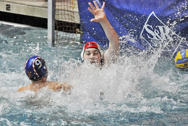 Auburn Mountainview's Jonah Kathlean scores a goal against Auburn Riverside goalkeeper Austin Butler.