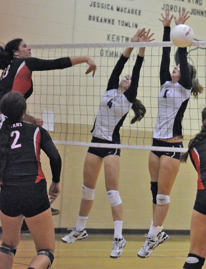 Carson Heilborn and Brenna Bruil block a shot by a Union player at the district tourney.