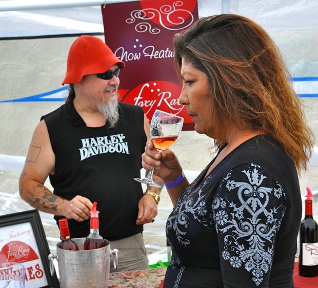 Holanda Madison samples some Foxy Roxy wine from Dean Evenson at the Auburn Wine Art Music Festival on Saturday.