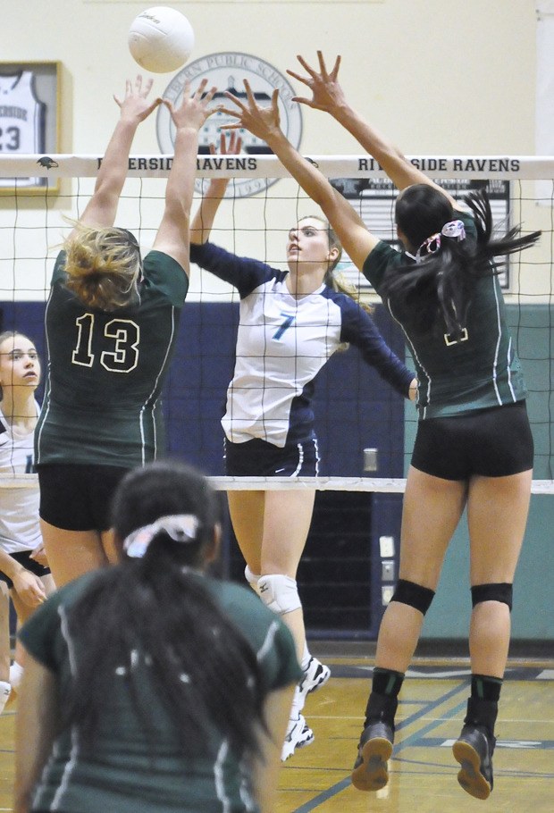 Auburn Riverside's Brenna Bruil drills the ball at the Kentwood defense during Tuesday night's match.