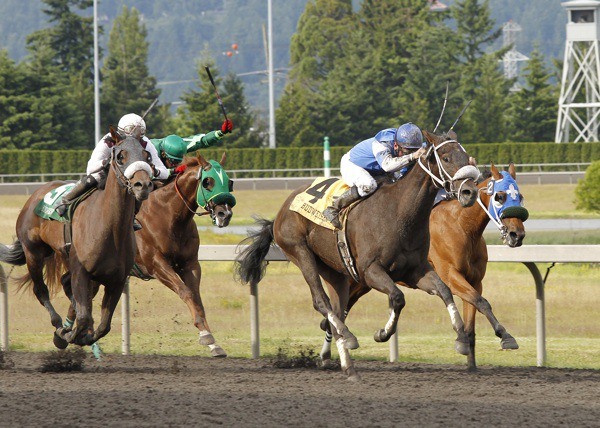 Jebrica (No. 4) and jockey Isaias Enriquez hold off Stryker Phd (No. 5) and jockey David G. Lopez to win the 18th running of the $50