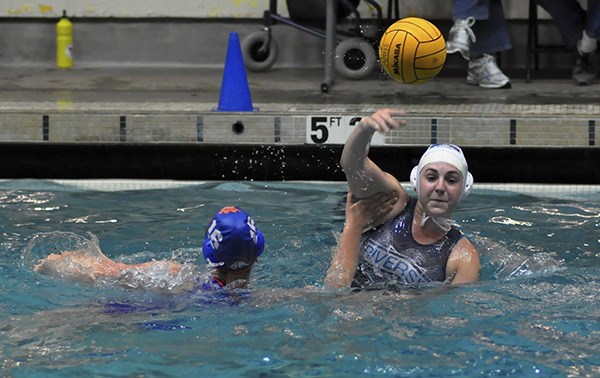 Auburn Riverside's Charissa Dorn passes over an Auburn Mountainview defender.