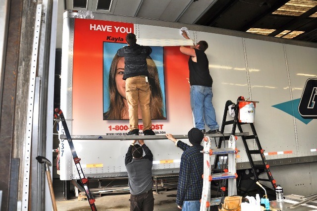 Gordon Truck workers put the poster of missing Kayla Croft-Payne on a truck in Pacific.