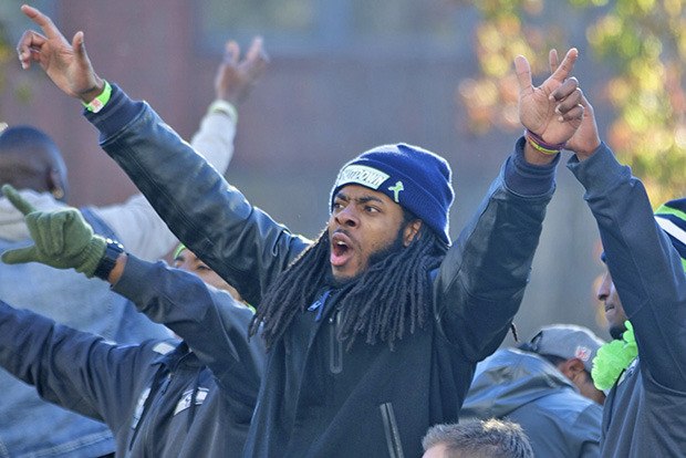 Seahawks cornerback Richard Sherman celebrates with fans along the packed parade route Wednesday.