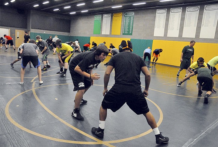 Auburn wrestlers practice under the supervision of coach Dennis Herren in a new mat room at the high school this year.