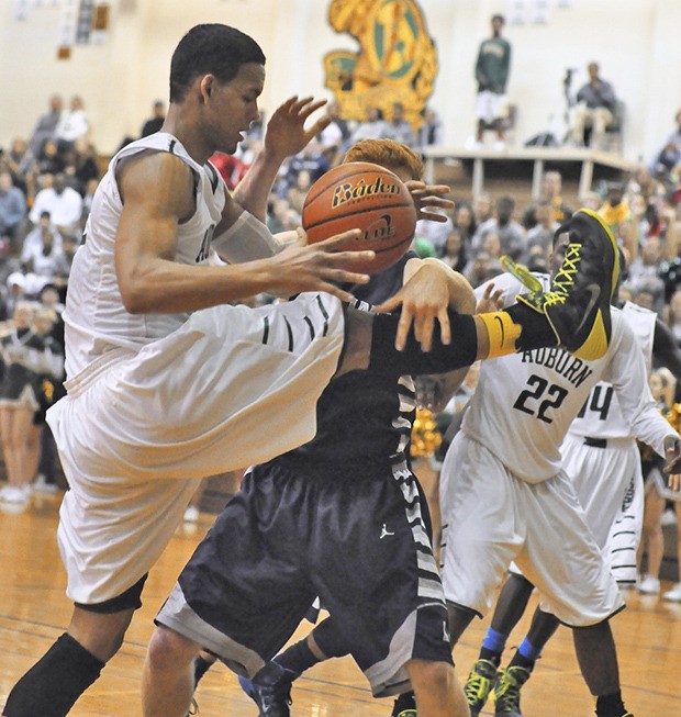 Auburn's Marquise Prater drives with the ball as Auburn Riverside's Andrew Wallen tries to block.