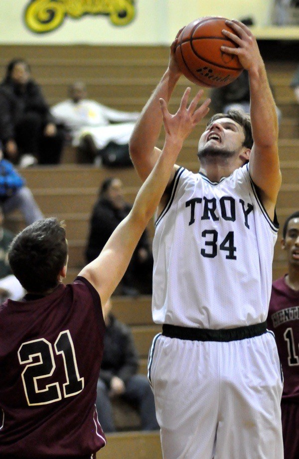 Auburn's Spencer Fisher pulls in a rebound against Kentlake.