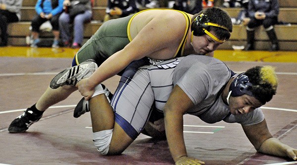 Auburn's Jacob Apodaca tangles with Auburn Riverside's Larkin Williams in the 285-pound division at the All-SPSL Championship wrestling tourney at Auburn High School.