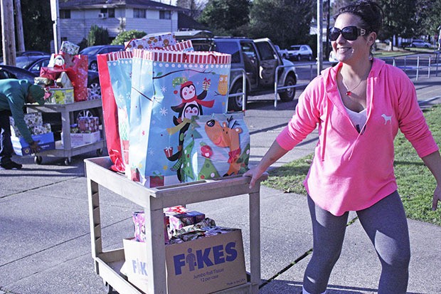 Autumn Hawkins basks in the sunshine as she pulls a cart of presents inside the school.