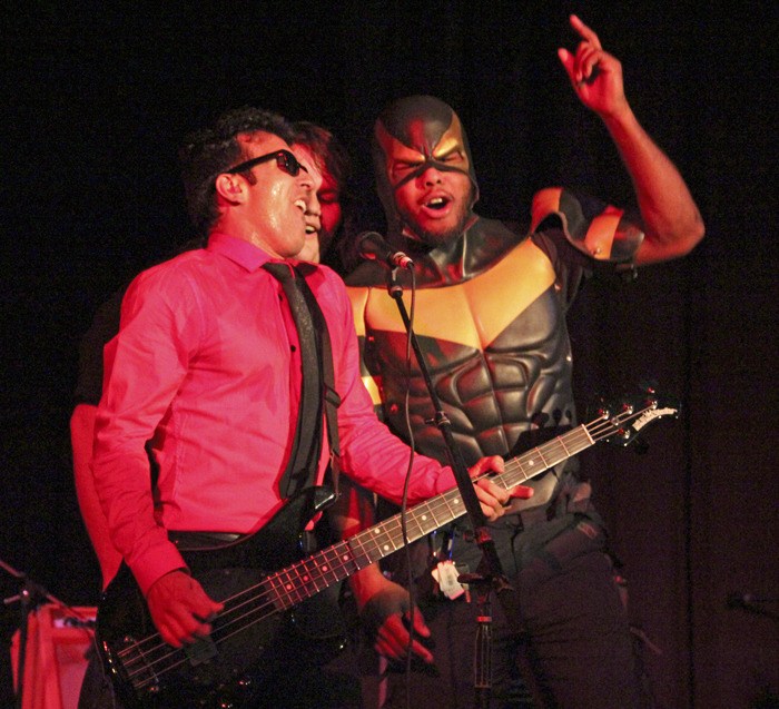 Quickie bassist and lead singer Lou Trez sings his band's ode to Seattle superhero 'Phoenix Jones' with the subject of the tune and KGRG's Ryder.