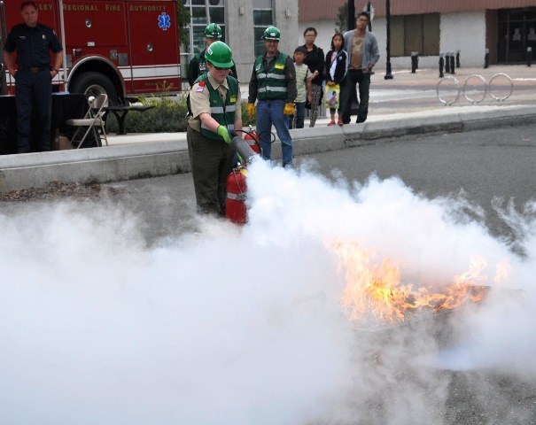 A CERT team shows a fire safety demonstration with Byron Kidder putting the fire out during the City of Kent Disaster Fair on Sunday.