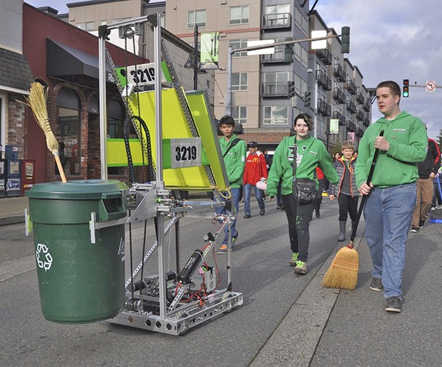 Auburn High Robot Club and its mechanized star scour Main Street in Clean Sweep