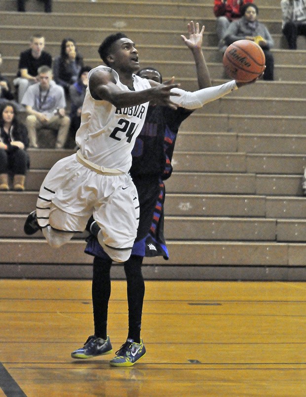 Auburn's Malik Williams drives for two of his team-high 23 points against Kent-Meridian on Wednesday night.