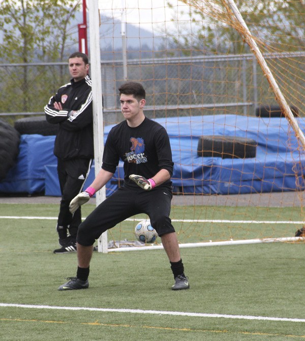 Auburn Mountainview's new boys soccer coach Jimmy Fioretti watches as junior goalkeeper Alex Fausko drills during practice.