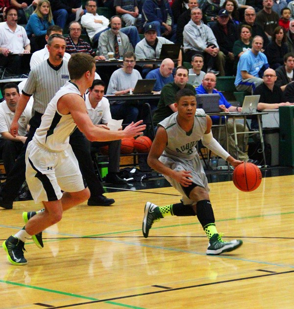 Auburn senior Harold Lee moves the ball up the court against a Jackson defender.