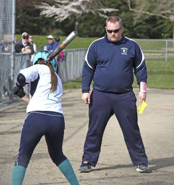 Auburn Riverside fastpitch coach Bryce Strand instructs a Raven player during a break at Game Farm Park.