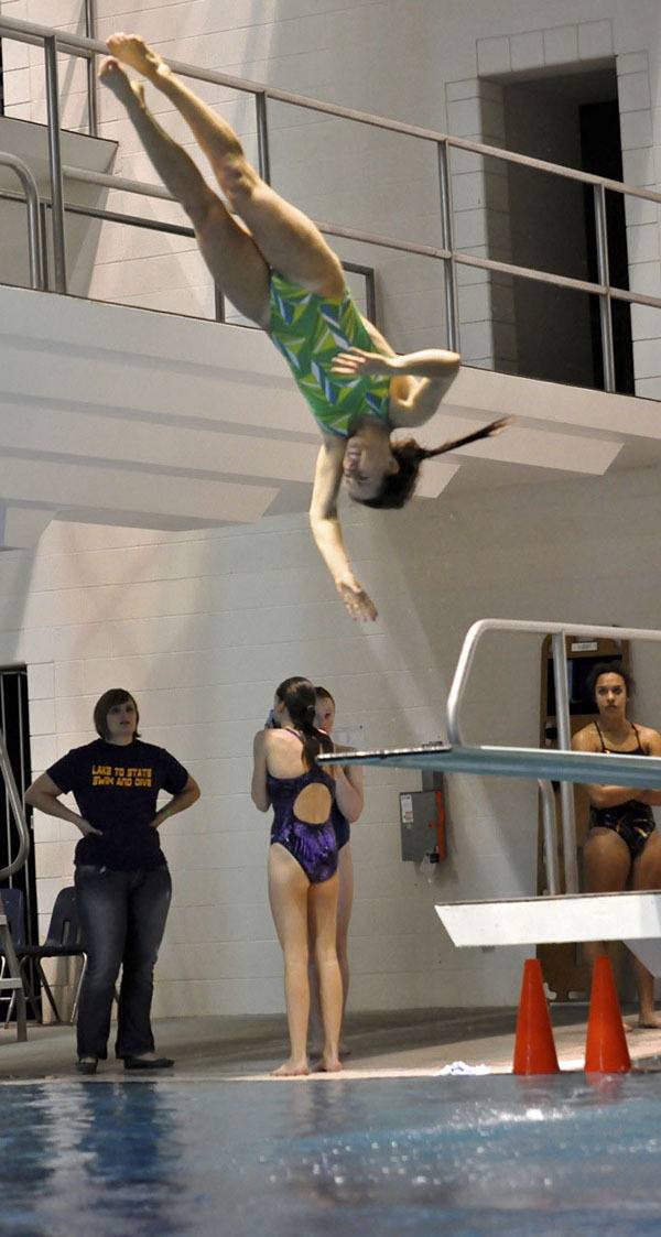 Hailey Kessler soars above the pool at the King County Aquatic Center in Federal Way during the Washington State 3A Diving Championships. Kessler captured the state title at the meet.