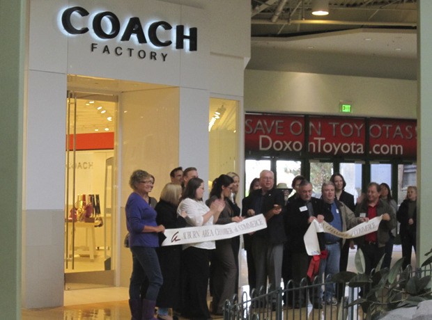 Representatives from the Auburn Area Chamber of Commerce joined Mayor Pete Lewis and Coach Factory staff in a ribbon-cutting ceremony.