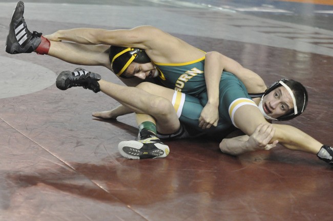 Auburn's Brian Alonzo tangles with Kamiak's David Garcia at the Washington State Mat Classic XXIV wrestling championships.