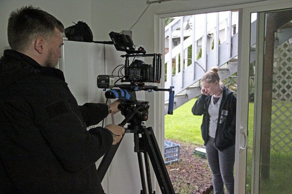 Director of photography Samuel Laseke sets up a shot on the set of 'An Appointment with Mr. Vield' with co-producer and actor Keri Barker.