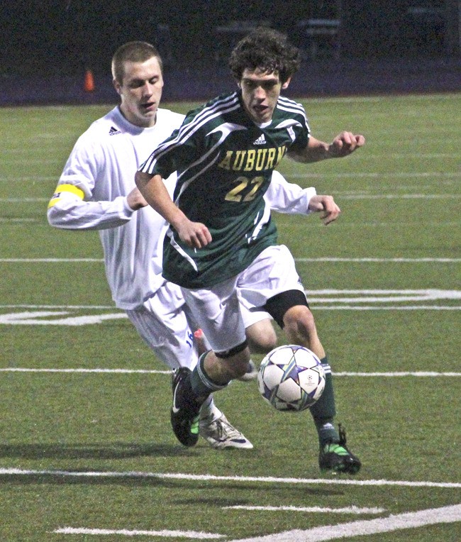 Auburn senior Eli Shaver drives past a Tahoma player.