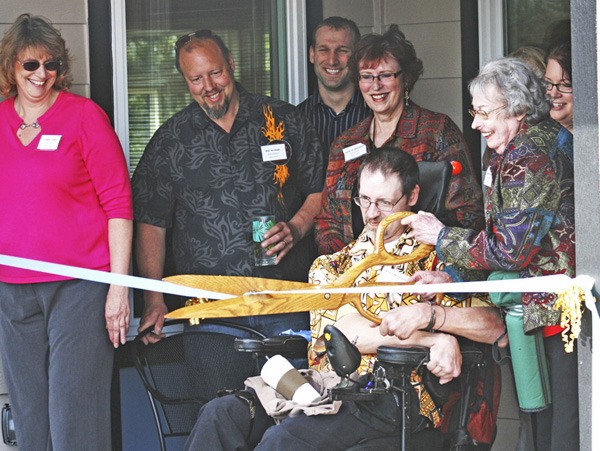 Terry Norman and his mother Mary Norman cut the ribbon at the opening of Auburn's Terry Home