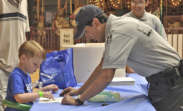 Auburn Police Explorer Alexander Lau helps Tyler Fleser