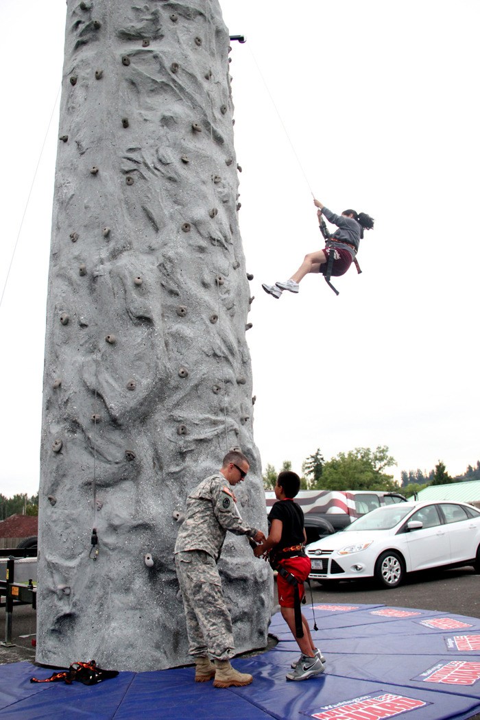 Sasha Sandoval and Alonzo Zaragoza conquer the National Guard climbing wall at Pacific's National Night Out event.