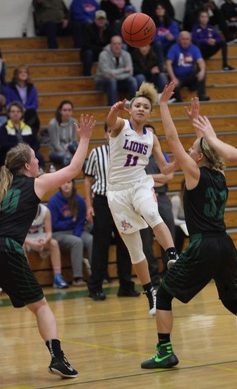 Auburn Mountainview's Brianna Zaragoza-Jones unloads a pass against Peninsula during district play. The Lions beat Peninsula 57-52 in overtime in an elimination game on Tuesday.